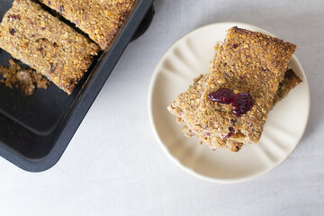 Several pieces of energy bars lie in a saucer. Selective focus. Healthy food concept. Horizontal orientation. Top view.