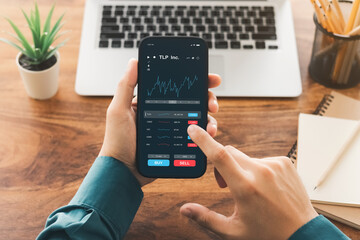 Businessmen work with stock market investments using smartphone to analyze trading data. smartphone with stock exchange graph on screen. Financial stock market.
