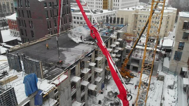 truck-mounted concrete pump works on the construction of a residential complex in the winter in the center of the city of Moscow, Russia.