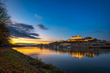 Fototapeta na wymiar Sunset over Bratislava castle, Slovak parliament and Danube river in Slovakia