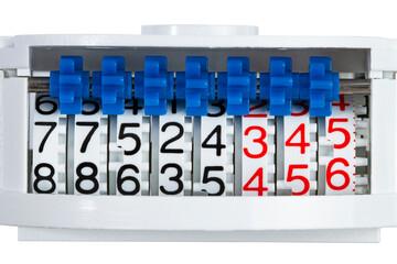 Wheels with numbers and gears, household meter for water or gas or electricity, close-up.