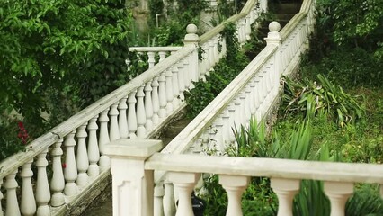 heavy rain falls on a gray staircase with white balusters