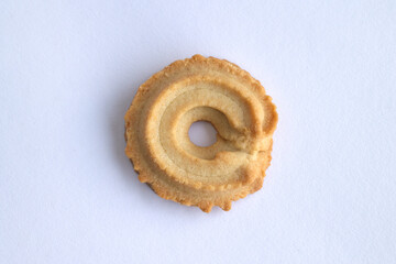 close up of Danish vanilla wreaths (vaniljekranse) cookies isolated on white background. homemade cracker in christmas traditional. yellow delicious bakery butter, top view