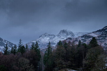 Obraz na płótnie Canvas Snow covers the Langdale Pikes in the English Lake District on a stormy winter day