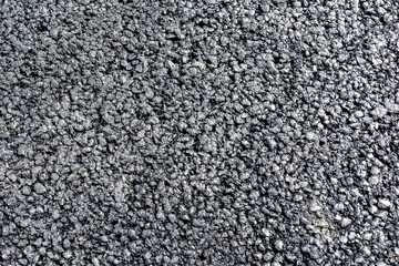 Old destroyed asphalt pavement as a background for the design. Texture and pattern of the building material.