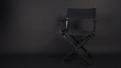 Fototapeta premium Black director chair use in video production , film, cinema industry on black background