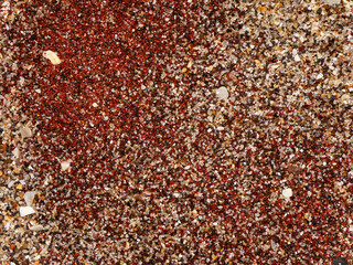 Texture of dry red clay with stones