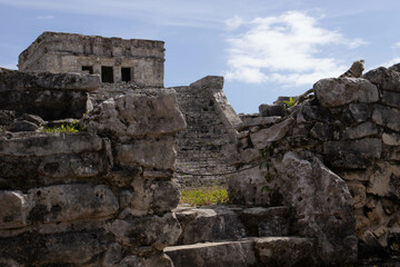 Fototapeta na wymiar Background of the Tulum castle, this is a Mayan ruin located on the beach of Tulum along the Riviera Maya being visited by many tourists on vacation in Mexico, next to the Caribbean Sea.