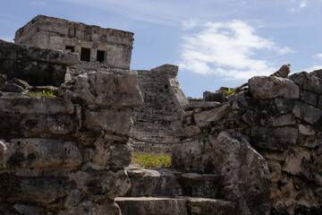 Fototapeta na wymiar Beautiful photo of the Tulum castle, this is a mayan ruin located on the Tulum beach along the Riviera Maya being visited by many tourists on vacation in Mexico, next to the caribbean sea.