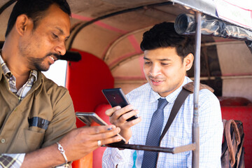 Auto rickshaw or cab passenger paying money by scanning qr code on mobile phone - concept of digital or online contactless payment and secure wireless transaction