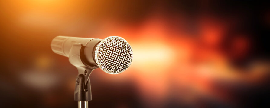 Microphone with stage light background for performance concept of speech comment and public speaking