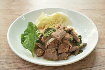 spicy slice pork liver Thai salad eat with fresh Gotu kolal leaf and cabbage on plate