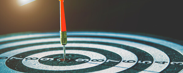 Bullseye target goal or dartboard has dart arrow throw hitting center shooting for financial business targeting planning to winner concept.