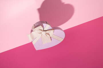 Valentine's day pink background. Minimal concept with paper heart. Mother day.