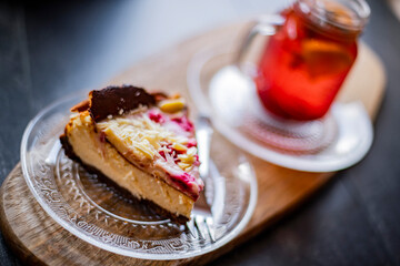 Cheesecake and a glass with hot fruit drink