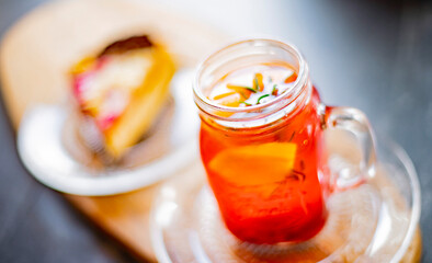 Cheesecake and a glass with hot fruit drink