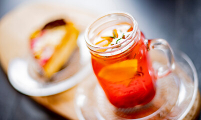 Cheesecake and a glass with hot fruit drink