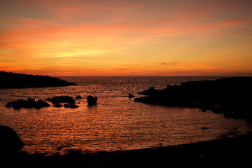 Cala Viola de Ponent, Menorca. September 2021. Magnificent sunset in the Mediterranean Sea. On one of the paradisaical beaches of the island of Menorca.