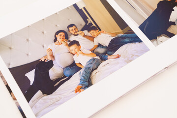 Obraz na płótnie Canvas the pages of a photobook with a big happy family pregnancy photo shoot. 