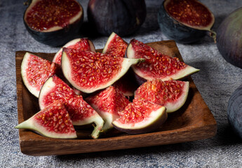 Some sliced figs in a wooden plate