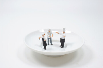 a group of  figures of chefs on saucer
