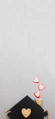 small toy house with red hearts from pipe on grey background. Concept of love , family