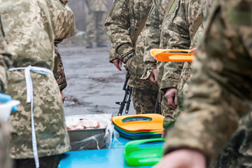 Military soldiers have lunch after an outdoor exercise in the field.