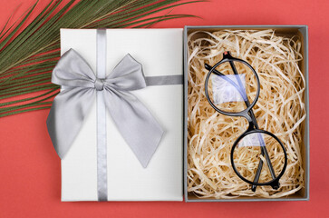 Stylish round glasses in a gift box. Gift or Sale of Stylish Optical Glasses