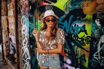 woman with a graffiti wall