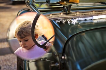 child in a oldtimer in funchal madeira portugal 
