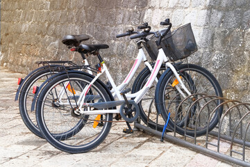 Fototapeta na wymiar Bicycle parking in Europe, biking station. Traveling around the city by bike.