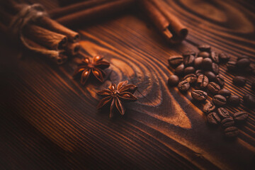 Anise stars with cinnamon sticks and coffee beans on a dark wooden background. Country style. 
