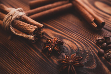 Anise stars with cinnamon sticks and coffee beans on a dark wooden background. Country style. 