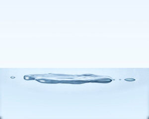 Water puddle from drops spilled onto surface. Water droplets splashed into a puddle of liquid. 