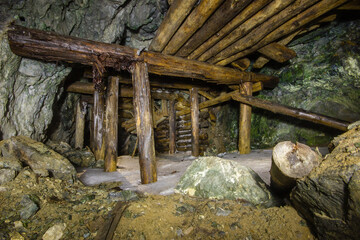 Underground gold mine tunnel with wooden timbering