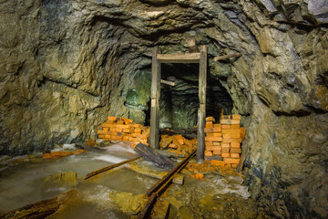 Fototapeta na wymiar Underground gold mine tunnel with wooden door