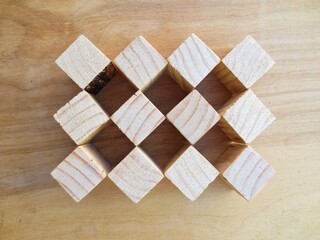 Blank wooden cube blocks on the table.
