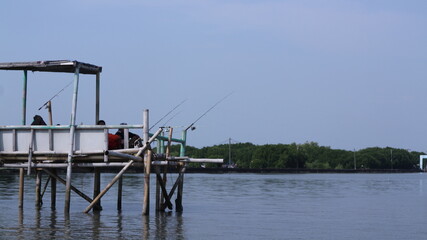 fishing in a small pavilion at the sea