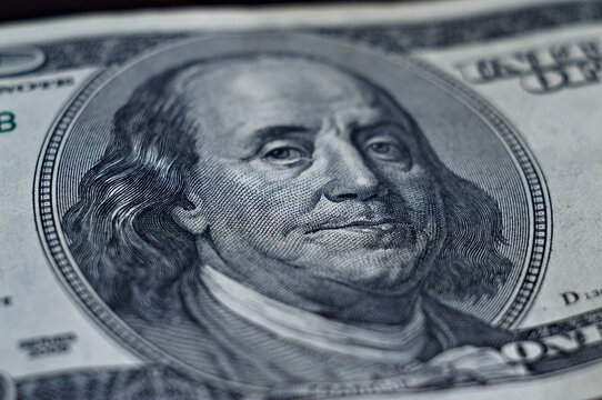 The image of Benjamin Franklin on a bill of one hundred US dollars, a macro shot
