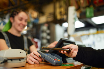 Client paying with smartphone via payment terminal