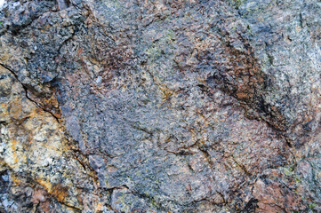 cracked rock, granite on the river bank
