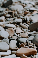 sea pebbles close-up in sunlight. Close-up of multicolored pebbles on the sea beach in the sunlight