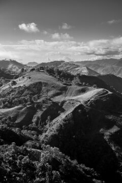 Dramatic black and white image of agricultural fields and farms high in the Caribbean mountains of the Dominican Republic.