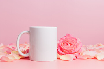 Mockup mug with rose and petals on pink background, coffee cup or mug for template and design