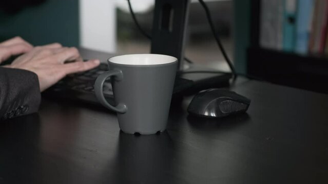 Close-up of Male Entrepreneur Spilling Coffee on his Desk while Working. Slow Motion. Business and Lifestyle Concept