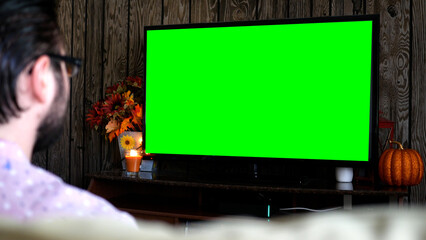 Millenial Hipster Man Watches Green Screen TV