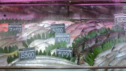 Beautiful fish stand full of assortment seafood products, selling and buying fresh row fish on the market
