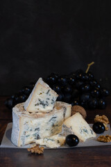 Gorgonzola blue mold cheese with grapes and nuts.