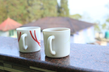 Beautiful morning background with coffee or tea cups closeup view.