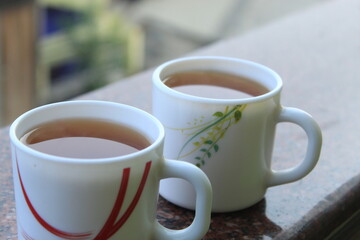 Beautiful morning background with coffee or tea cups closeup view.